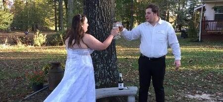 couple making toast after elopement